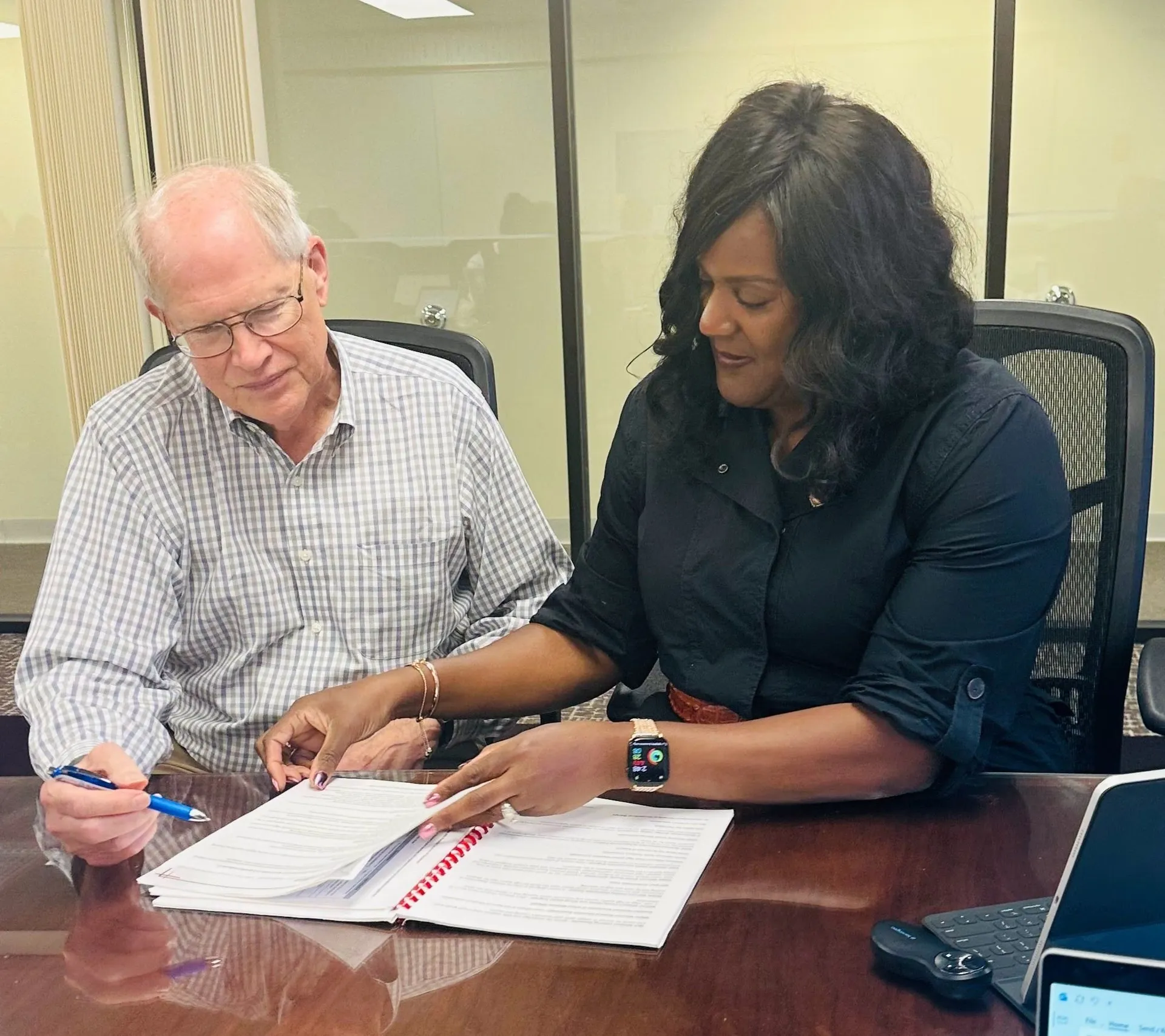 Dr. Keisha Scarlett reviewing documents with a colleague at a table